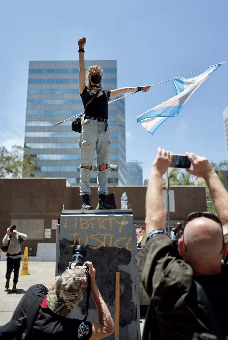 Gerry Duggan picture of a person holding a trans flag at Los Angeles's No Kings protest